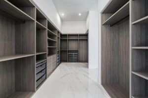 Elegant walk-in closet with ample shelving and storage in a modern design.