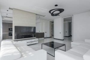 Bright and contemporary living room with sleek white furniture and modern decor.